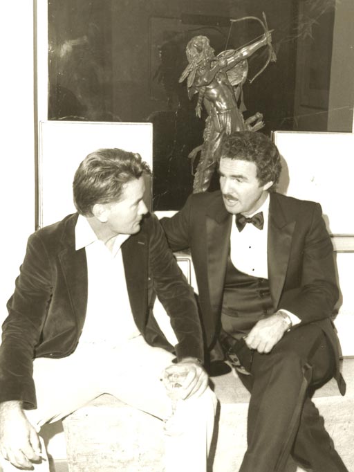 Burt Reynolds and Martin Sheen with a Great American Bronze Works sculpture